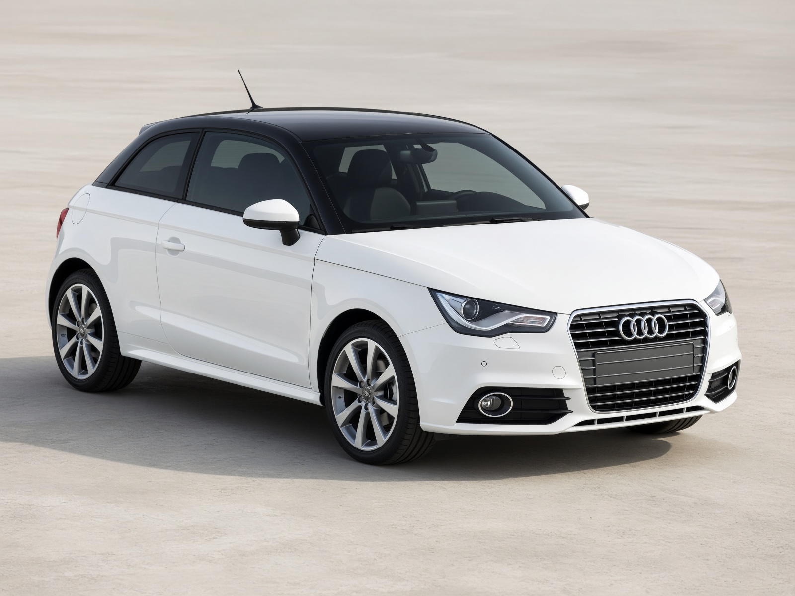 White Audi A1 with a black roof, three-quarter front view